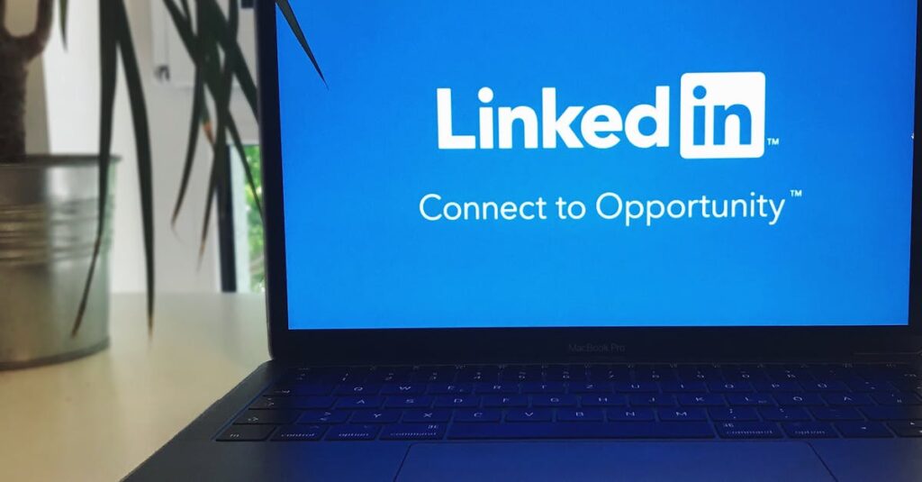 A laptop screen displaying the LinkedIn logo with the text 'Connect to Opportunity'.