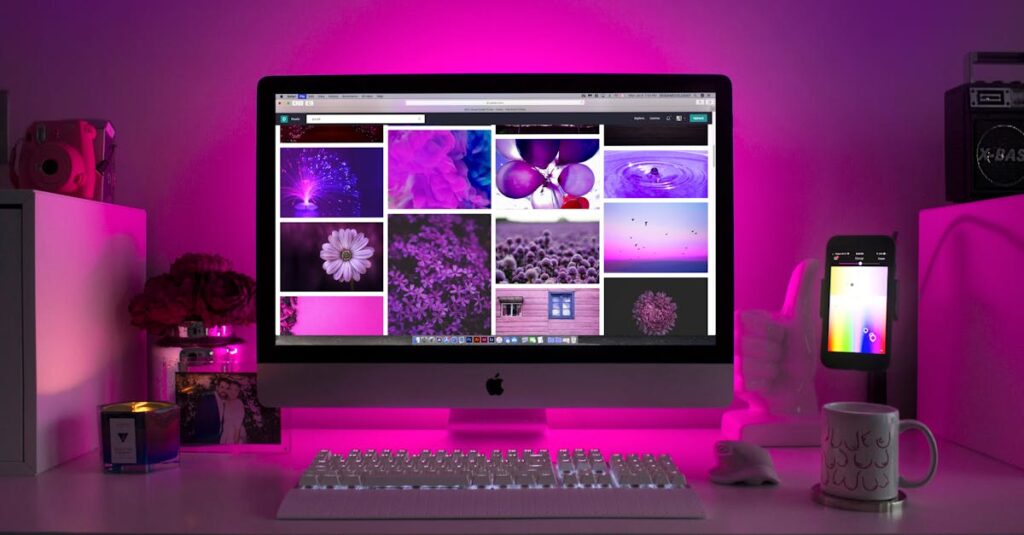 Modern desk setup with neon lighting and a desktop computer displaying colorful images.