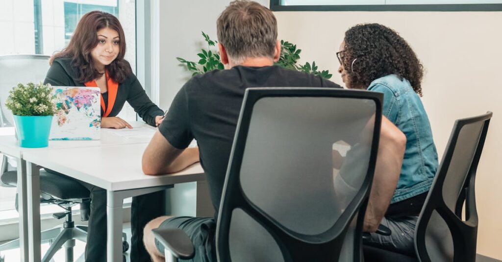 A business advisor consults with clients in a modern office setting, fostering teamwork and cooperation.