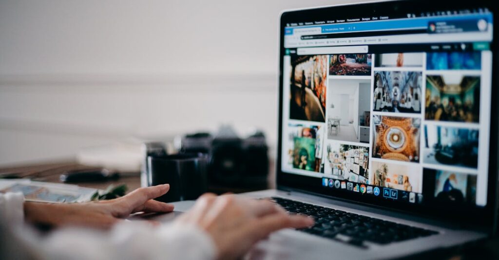 Close-up of hands using laptop for image searching and browsing digital photo gallery.